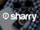логотип і назва компанії Sharry на фоні фотоапарата та окулярів